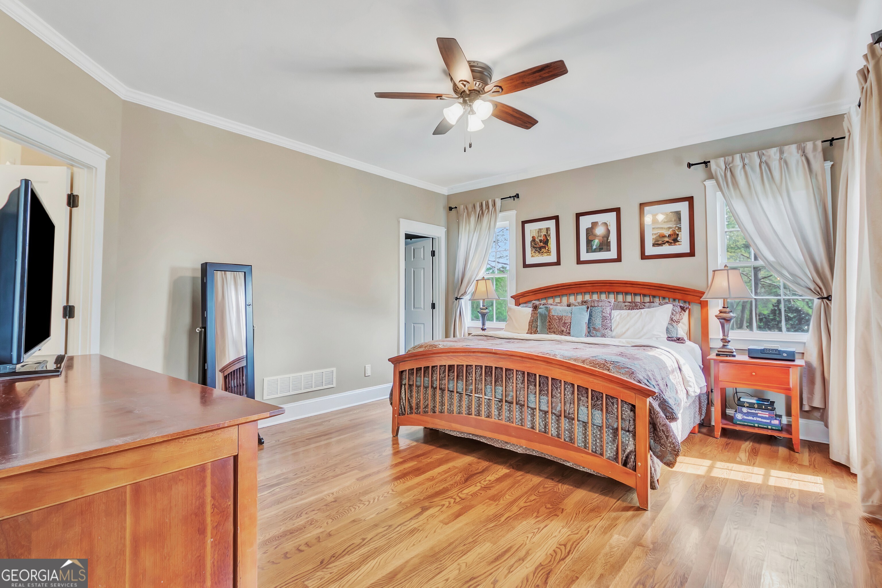 388 Swanson Road Tyrone, GA 30290 - Photo 25 of 62 a bedroom with a bed and a flat tv screen on dresser