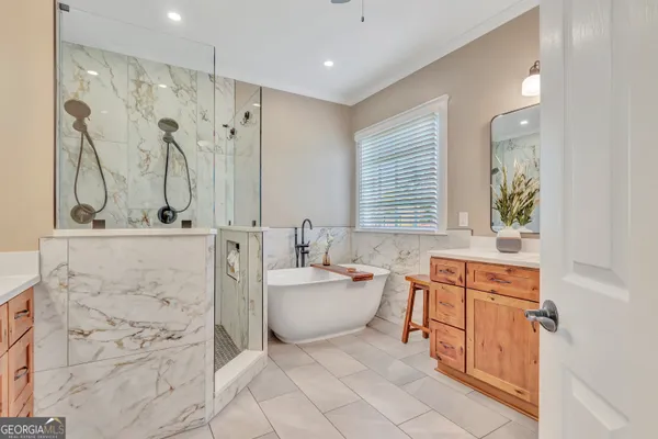 a bathroom with a granite countertop sink mirror vanity and toilet