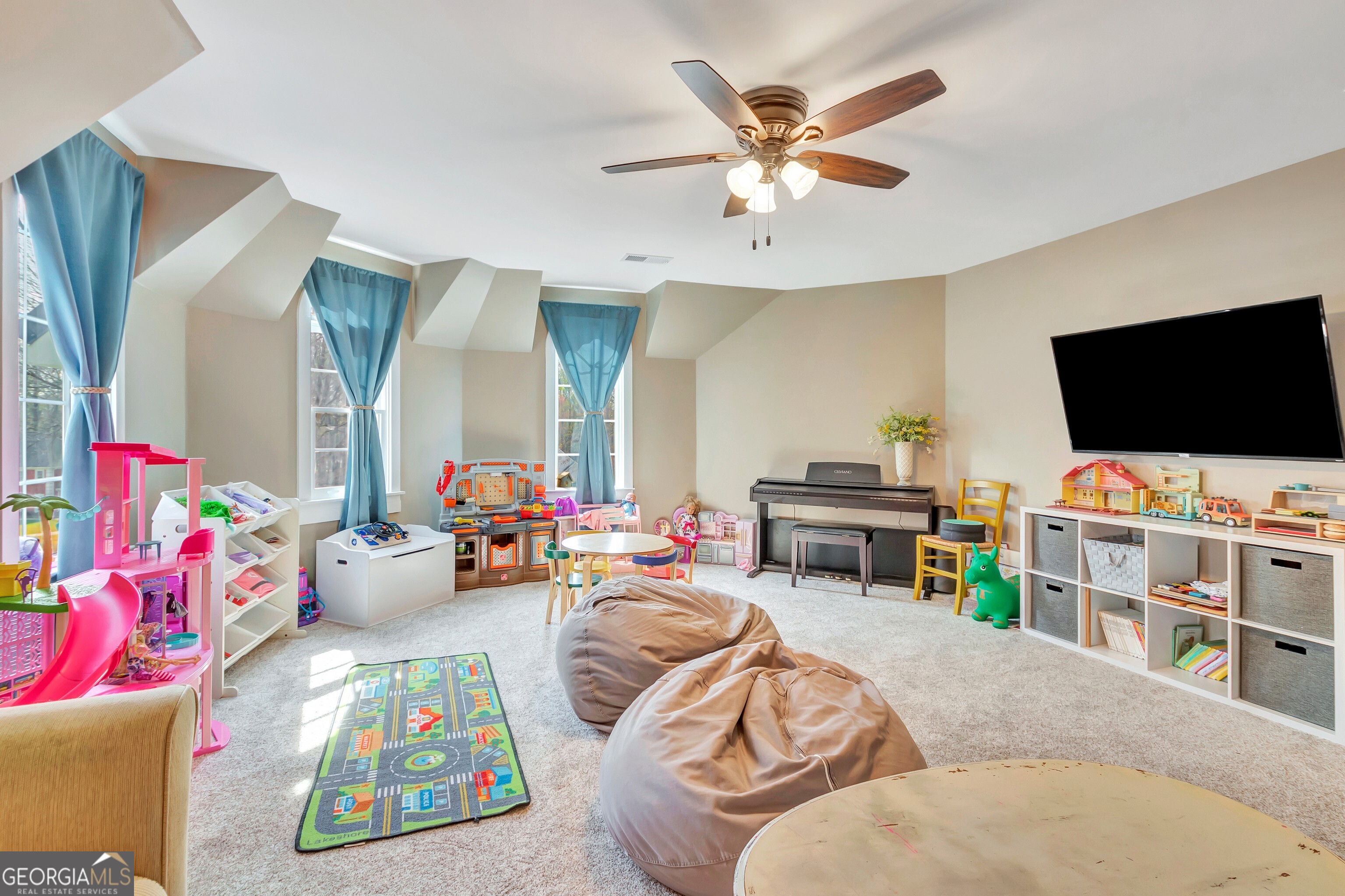 388 Swanson Road Tyrone, GA 30290 - Photo 35 of 62 a living room with furniture and a flat screen tv