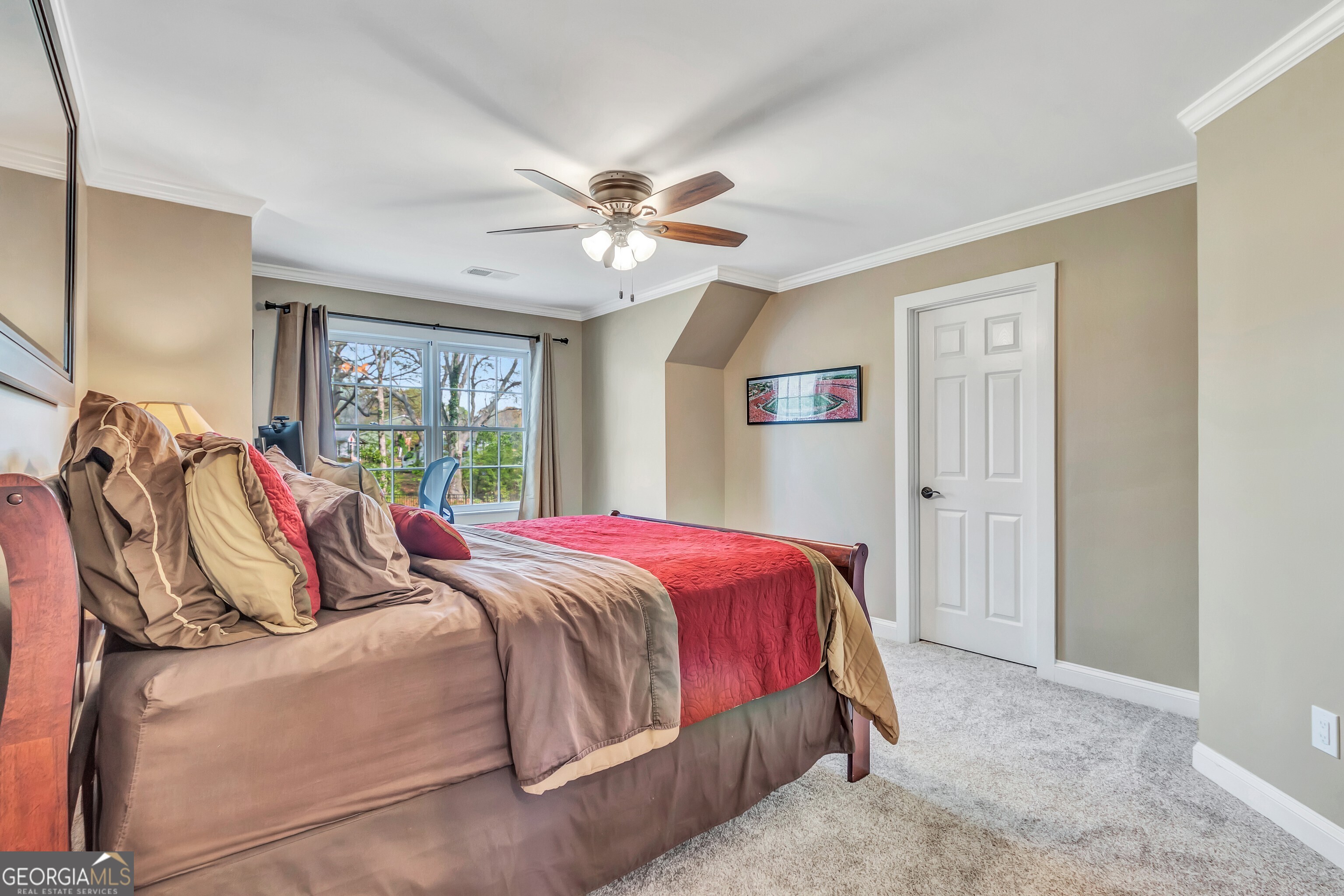 388 Swanson Road Tyrone, GA 30290 - Photo 38 of 62 a bedroom with a large bed and a chandelier