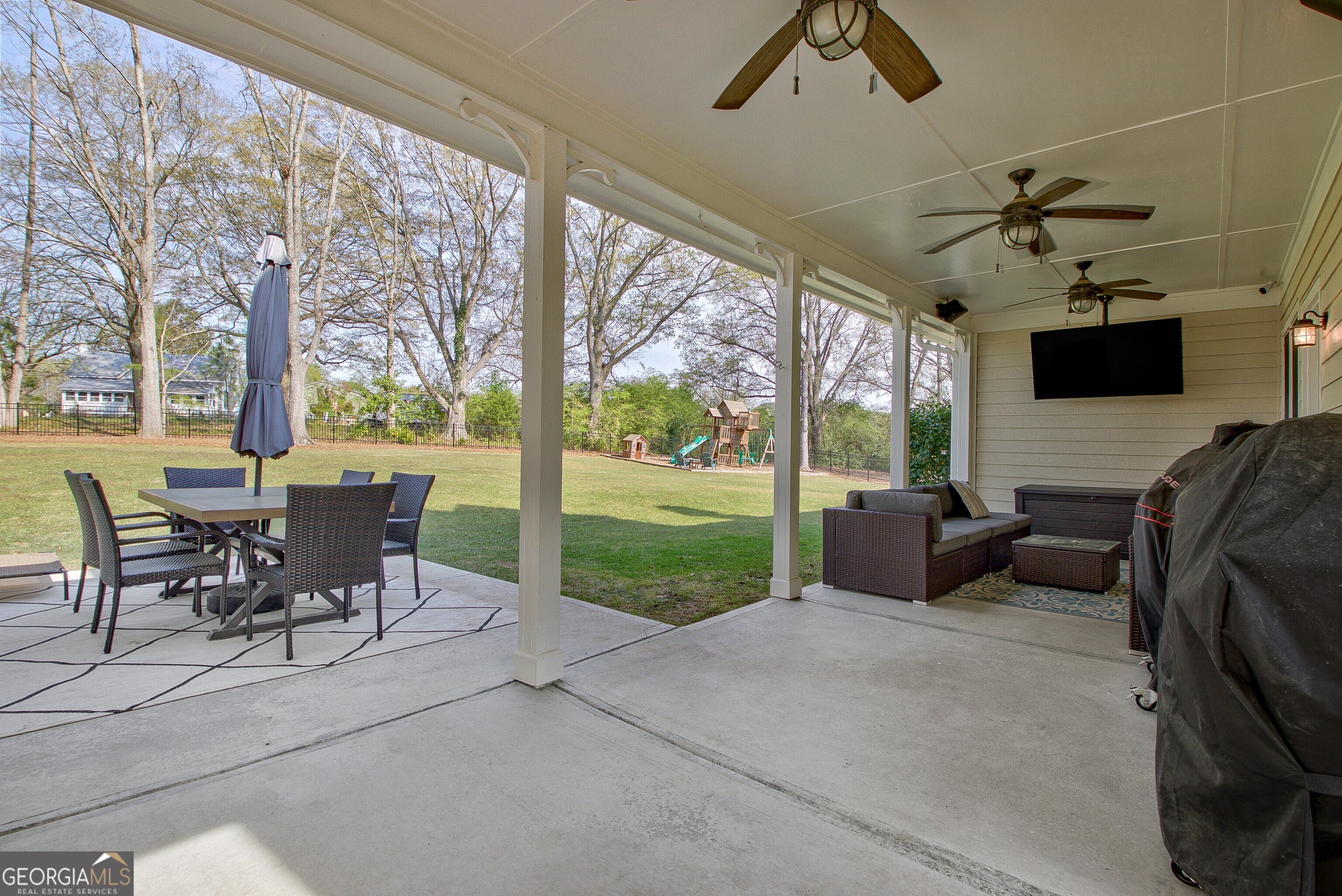 388 Swanson Road Tyrone, GA 30290 - Photo 42 of 62 a view of a patio with a dining table and chairs