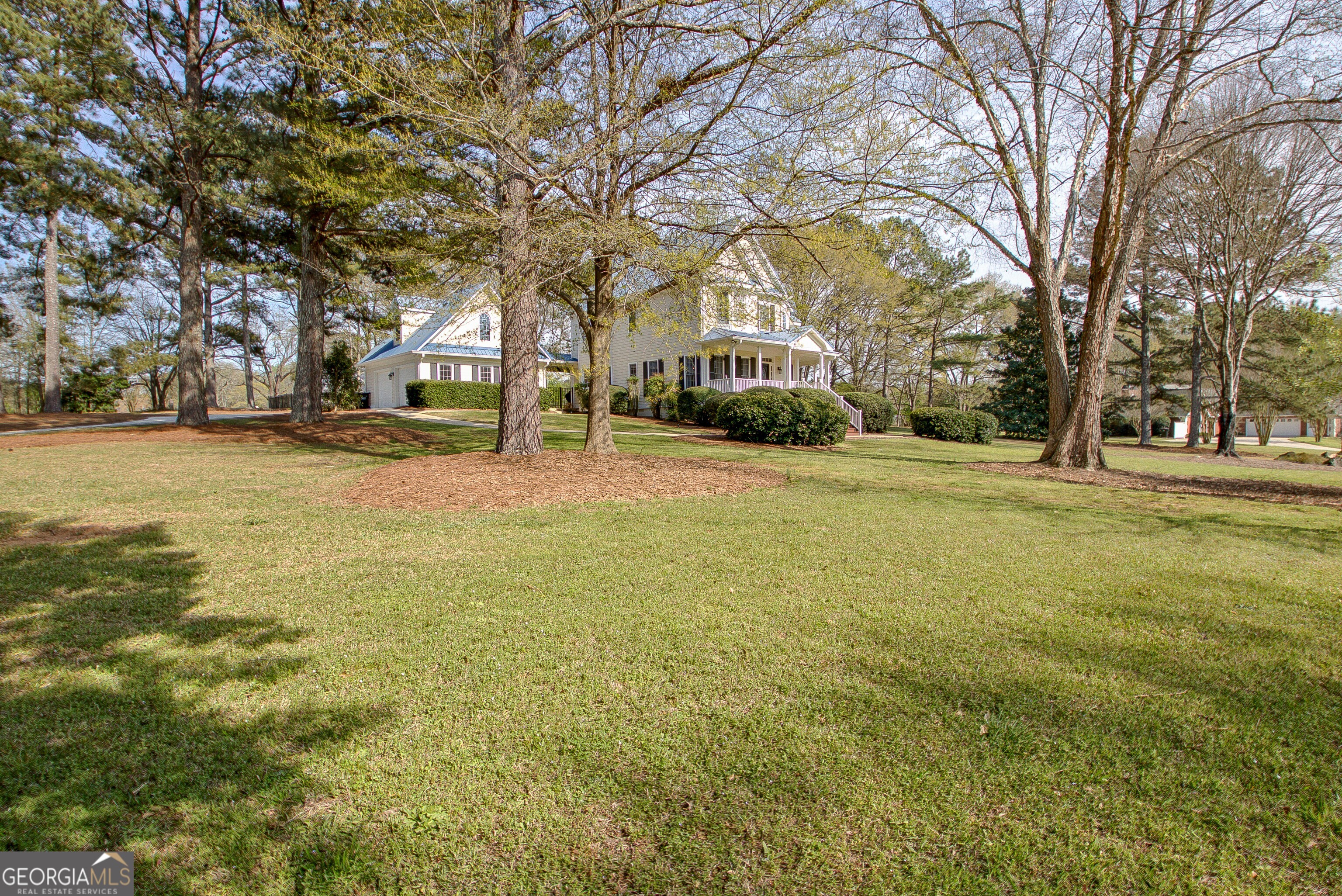 388 Swanson Road Tyrone, GA 30290 - Photo 50 of 62 a yellow house with trees in front of it