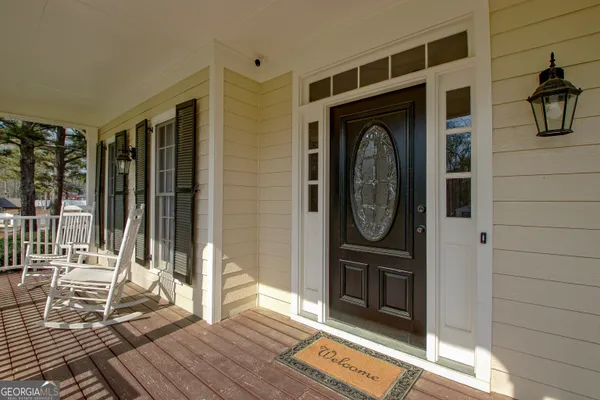 a view of front door deck and patio
