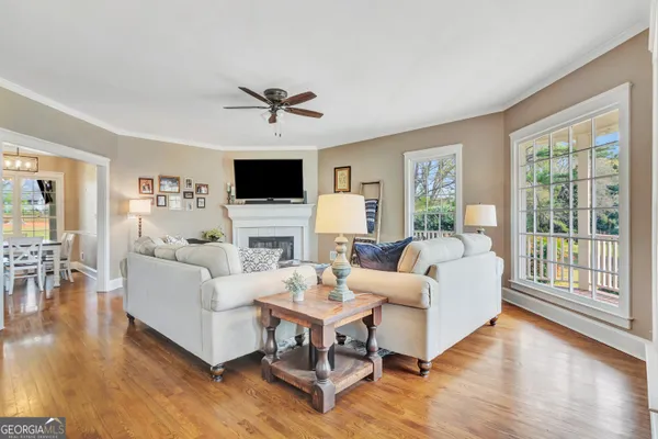 a living room with fireplace furniture and a flat screen tv