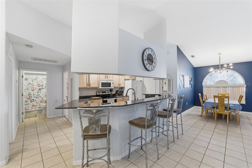 5220 Kirkwood Avenue Spring Hill, FL 34608 - Photo 11 of 67 a kitchen with a dining table and chairs