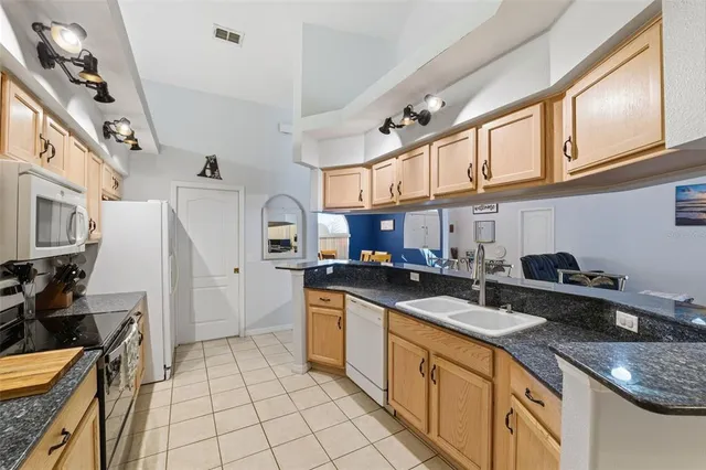a bedroom with a bed and a flat tv screen on dresser