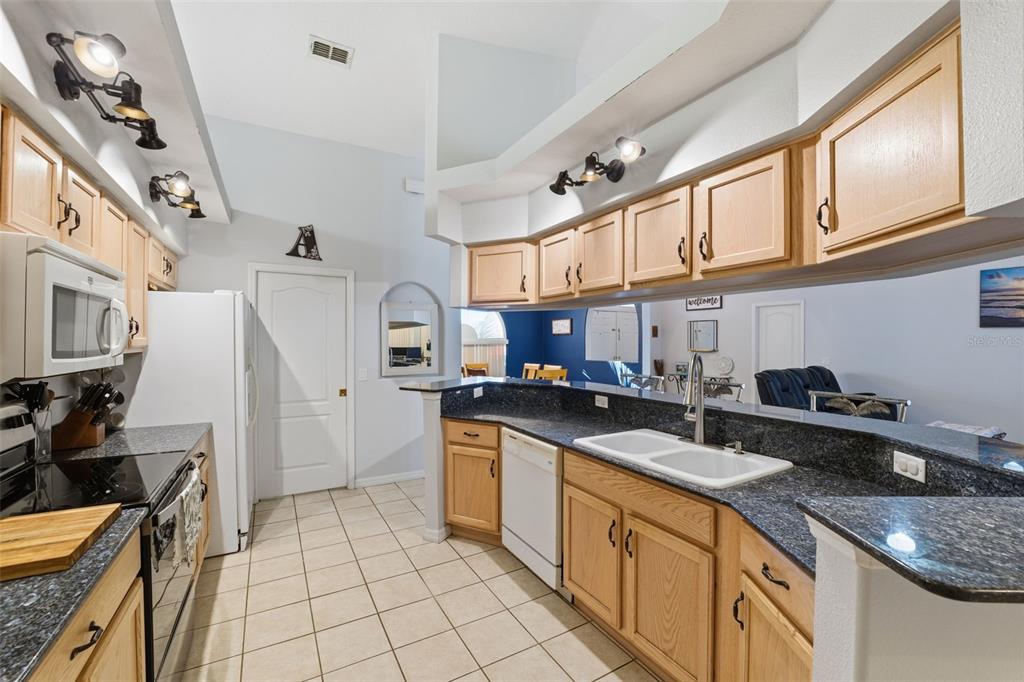 5220 Kirkwood Avenue Spring Hill, FL 34608 - Photo 14 of 67 a kitchen with stainless steel appliances granite countertop a stove and a sink