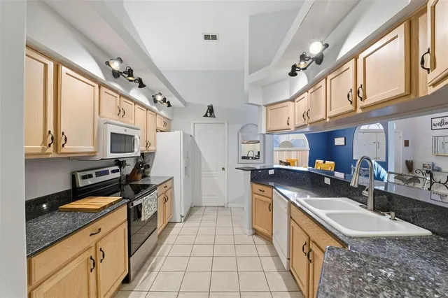 a spacious bathroom with a granite countertop sink mirror and vanity