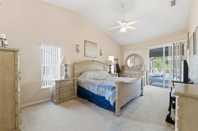 a bedroom with a white bed and a chandelier