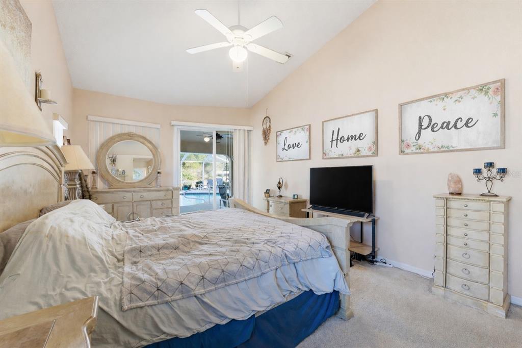 5220 Kirkwood Avenue Spring Hill, FL 34608 - Photo 19 of 67 a bedroom with a bed and a flat tv screen on dresser