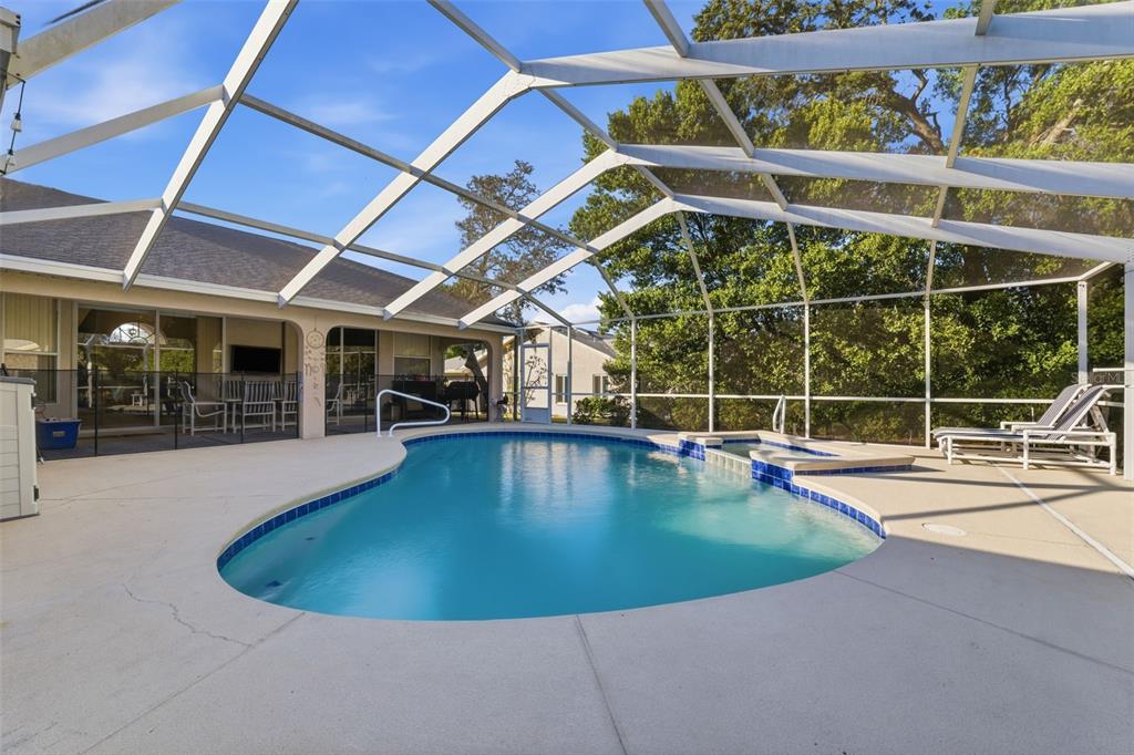 5220 Kirkwood Avenue Spring Hill, FL 34608 - Photo 2 of 67 a view of a swimming pool with a patio