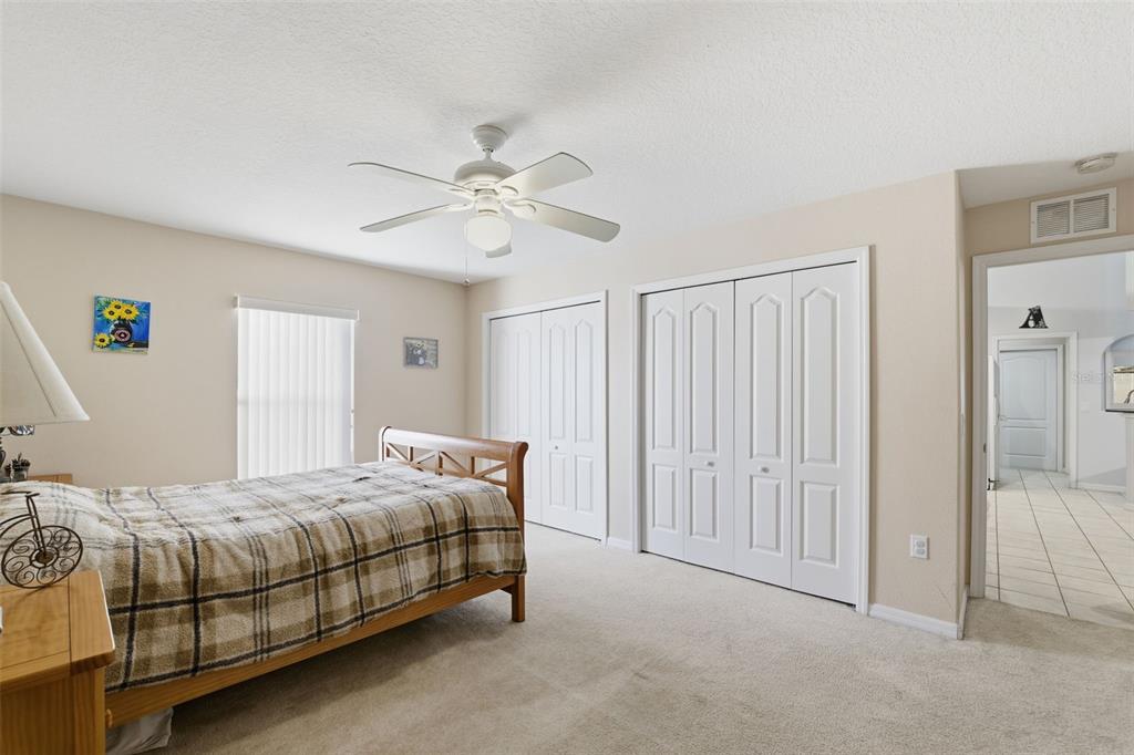 5220 Kirkwood Avenue Spring Hill, FL 34608 - Photo 25 of 67 a bedroom with a bed and a chandelier