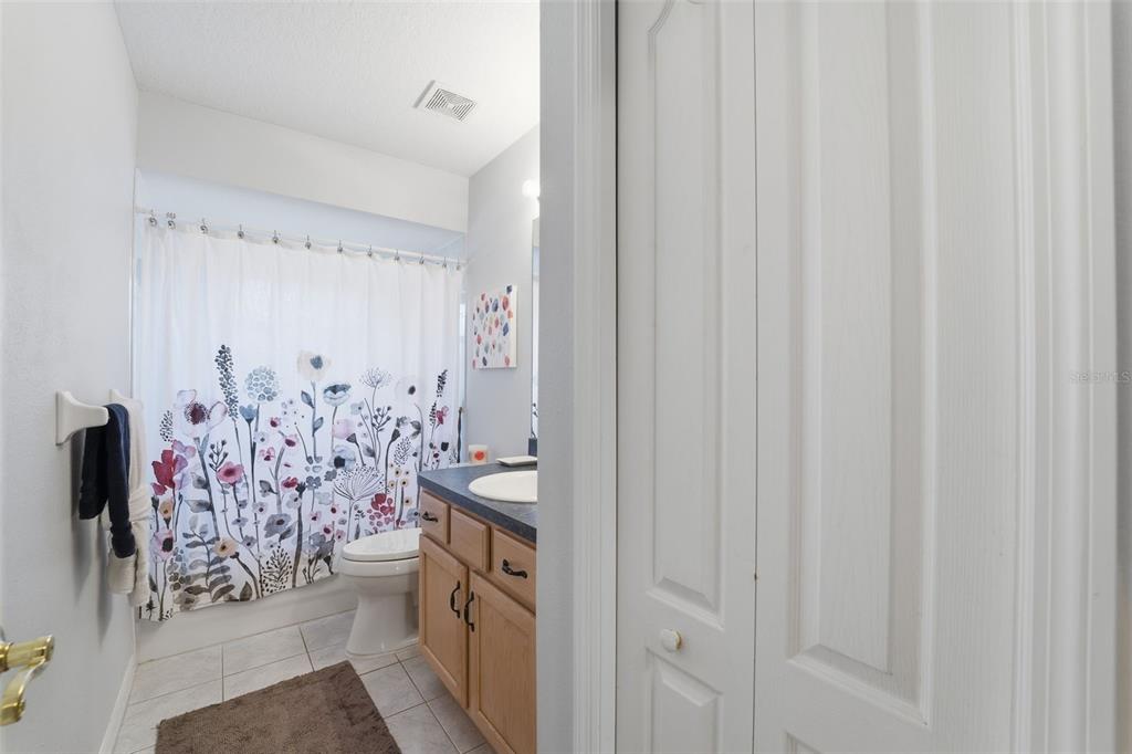 5220 Kirkwood Avenue Spring Hill, FL 34608 - Photo 26 of 67 a bathroom with a shower curtain and a curtain