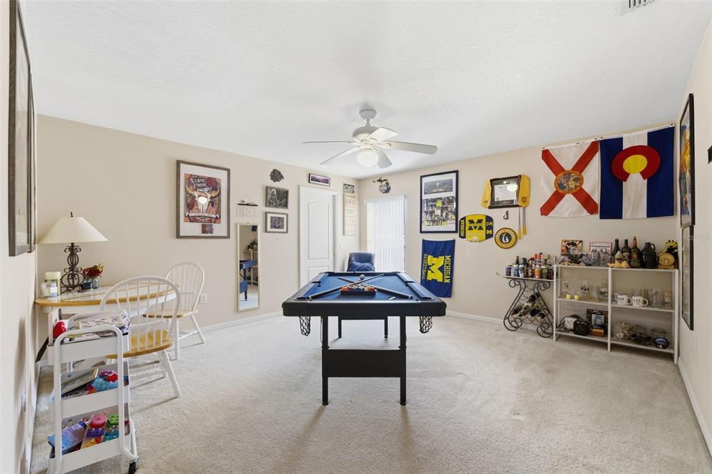 5220 Kirkwood Avenue Spring Hill, FL 34608 - Photo 31 of 67 a living room with furniture and a chair