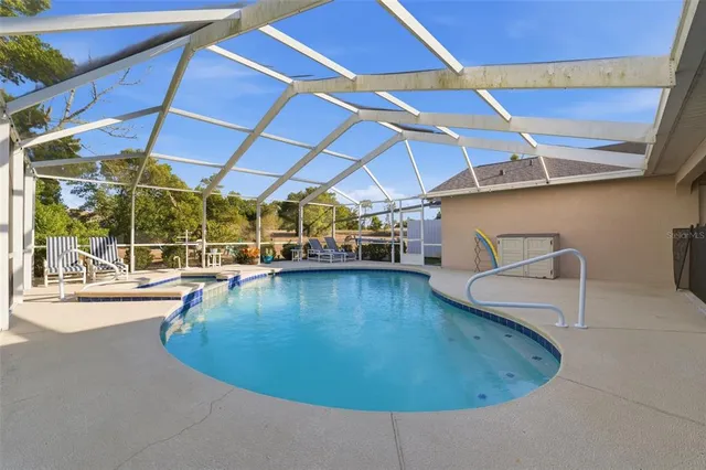 an aerial view of a house with a yard and lake view