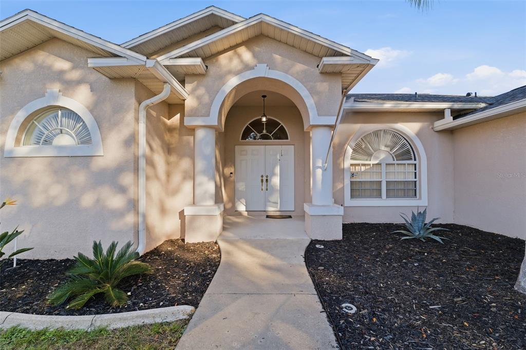 5220 Kirkwood Avenue Spring Hill, FL 34608 - Photo 4 of 67 a front view of a house with garden
