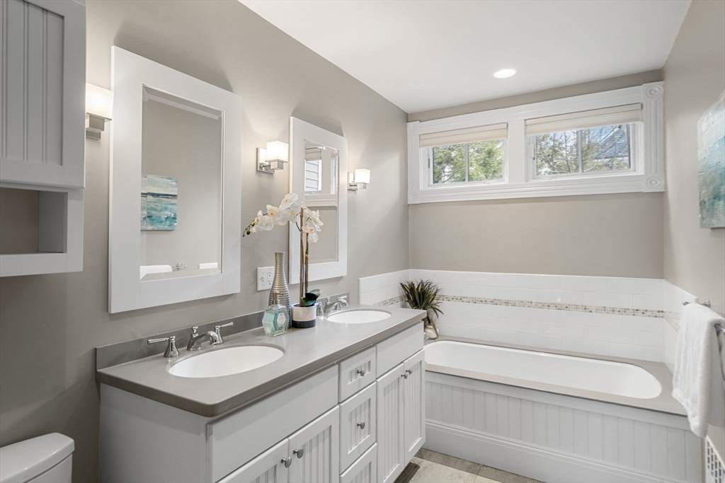 44 Putnam Street Newton, MA 02465 - Photo 25 of 38 a bathroom with a sink and a mirror