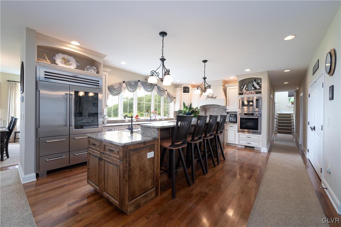 53 Airport Road Millville, PA 17846 - Photo 11 of 77 a kitchen with stainless steel appliances granite countertop a table chairs stove and refrigerator
