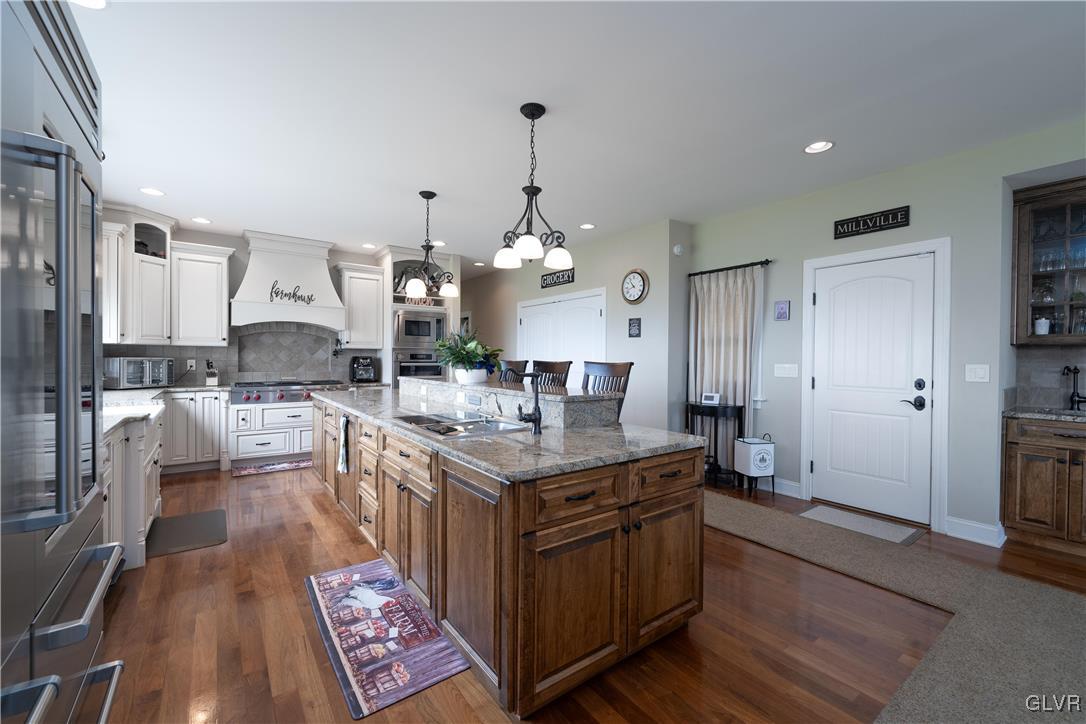 53 Airport Road Millville, PA 17846 - Photo 15 of 77 a kitchen with stainless steel appliances granite countertop a sink stove and refrigerator
