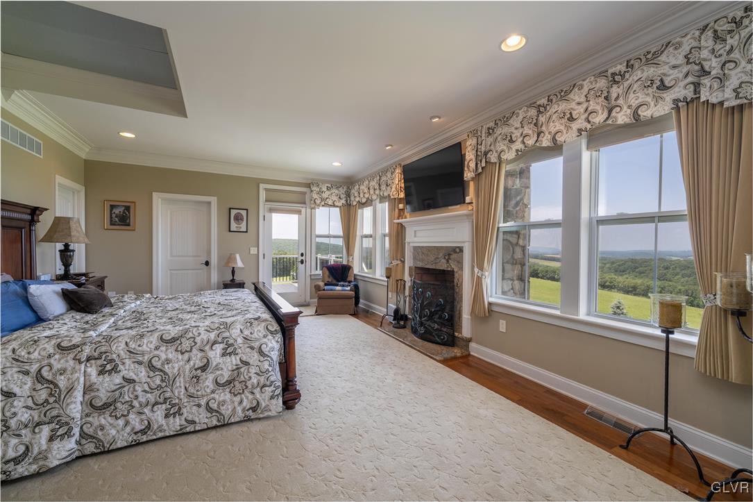 53 Airport Road Millville, PA 17846 - Photo 20 of 77 a spacious bedroom with a large bed and a fireplace