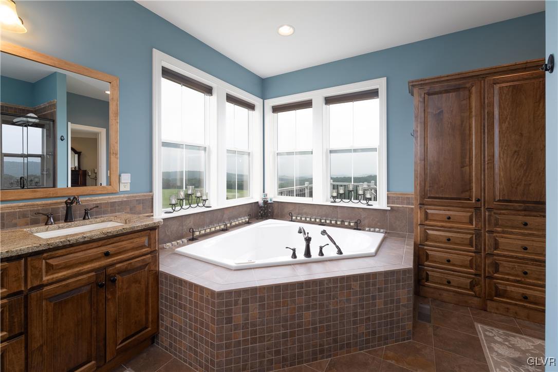 53 Airport Road Millville, PA 17846 - Photo 25 of 77 a bathroom with a tub a sink and a window