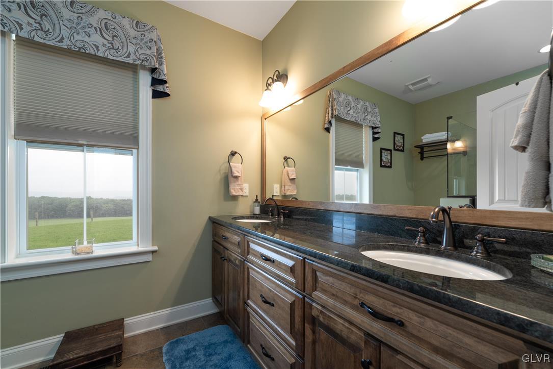 53 Airport Road Millville, PA 17846 - Photo 30 of 77 a bathroom with a granite countertop sink a large mirror a and a window