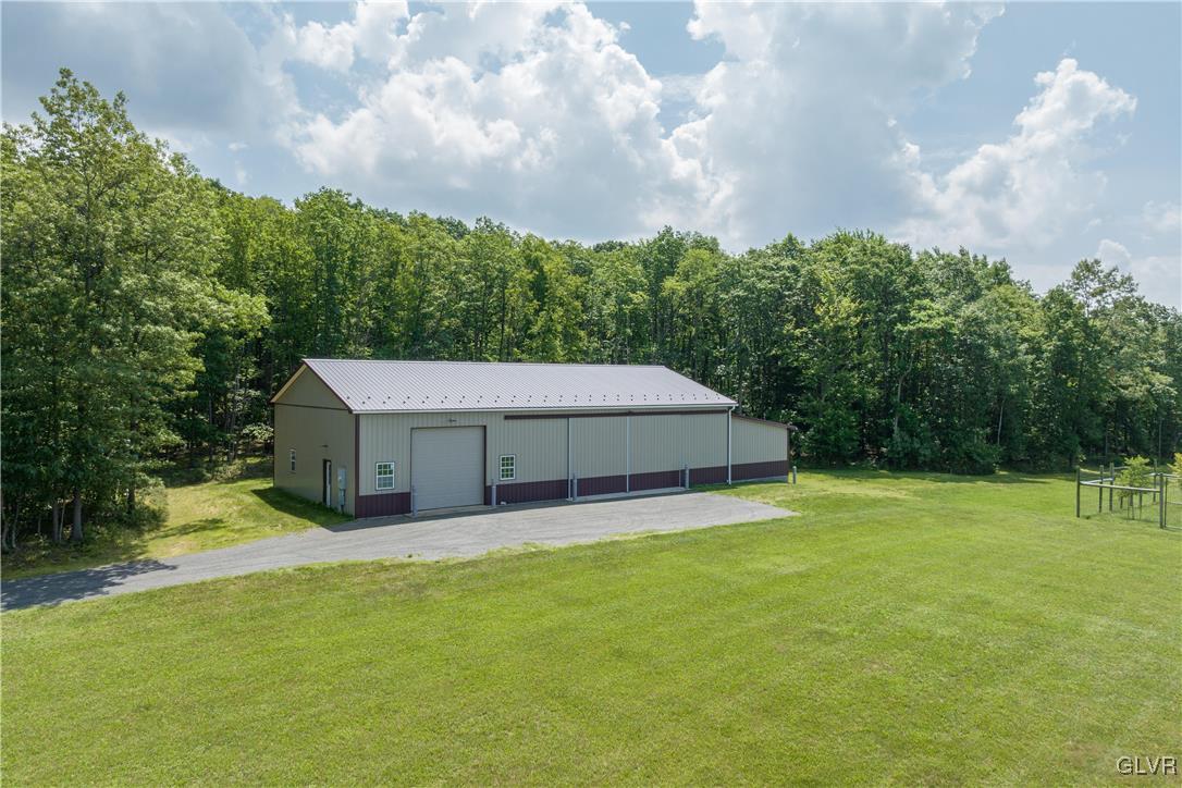 53 Airport Road Millville, PA 17846 - Photo 51 of 77 a view of a house with a big yard and a large tree