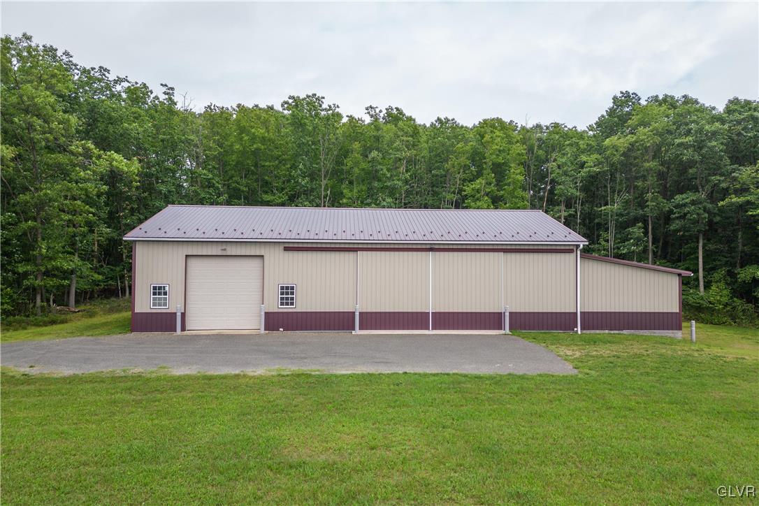 53 Airport Road Millville, PA 17846 - Photo 52 of 77 a view of a backyard with a garden and entertaining space