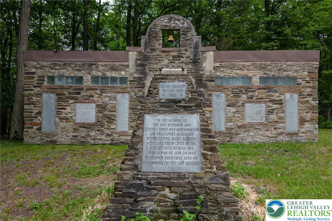53 Airport Road Millville, PA 17846 - Photo 77 of 77 front view of a stone house with a yard