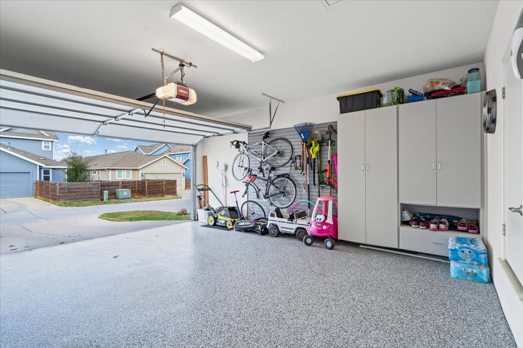 5912 Corrine Lane Austin, TX 78747 - Photo 23 of 27 Garage featuring automatice garage opener, epoxy flooring and built-in storage