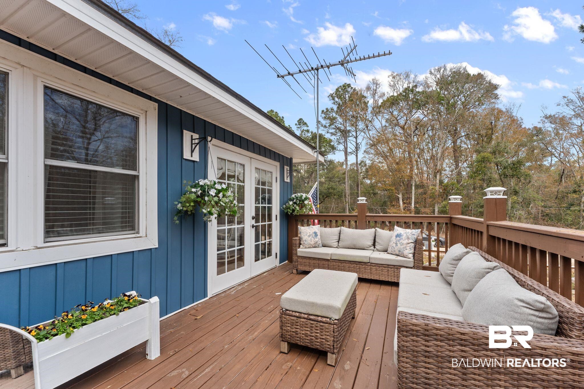 3881 Oregon Avenue Coden, AL 36523 - Photo 2 of 19 Wooden terrace featuring french doors and an outdoor hangout area