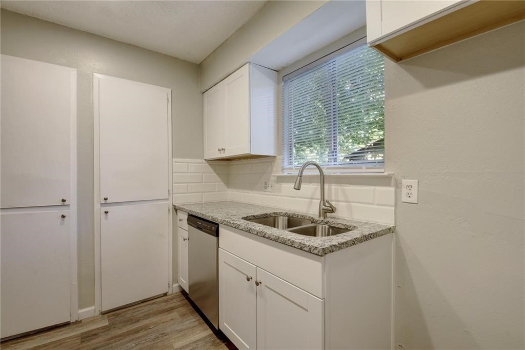 2311 Teri Road, Unit B Austin, TX 78744 - Photo 9 of 25 a kitchen with granite countertop a sink and a window