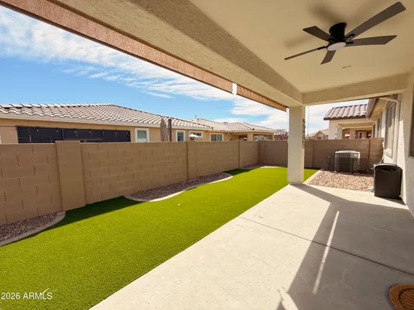 a backyard of a house with table and chairs