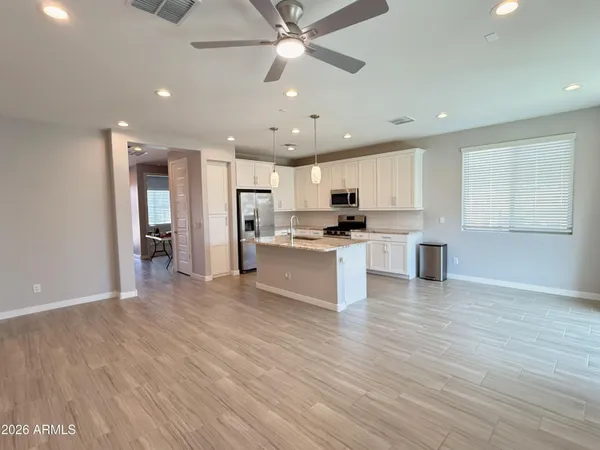 a view of kitchen with cabinets microwave and wooden floor