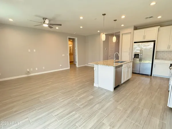 a kitchen with stainless steel appliances a refrigerator and a stove top oven