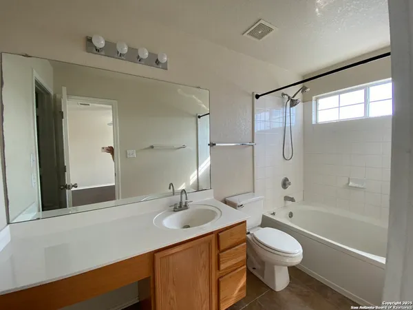 a bathroom with a sink toilet a shower and a mirror