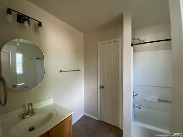 a bathroom with a sink and mirror