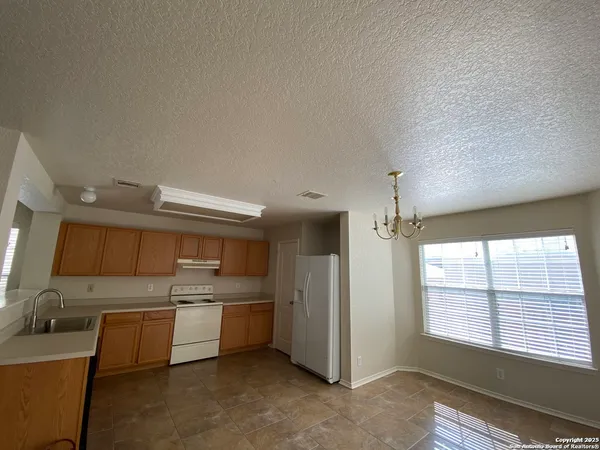 a kitchen with a sink cabinets and window