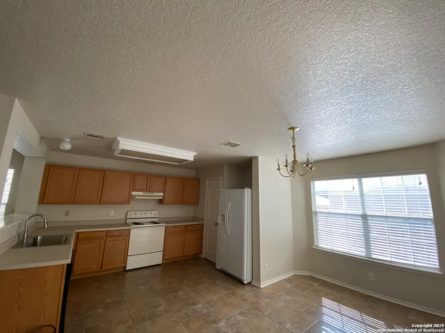 a kitchen with a sink cabinets and window
