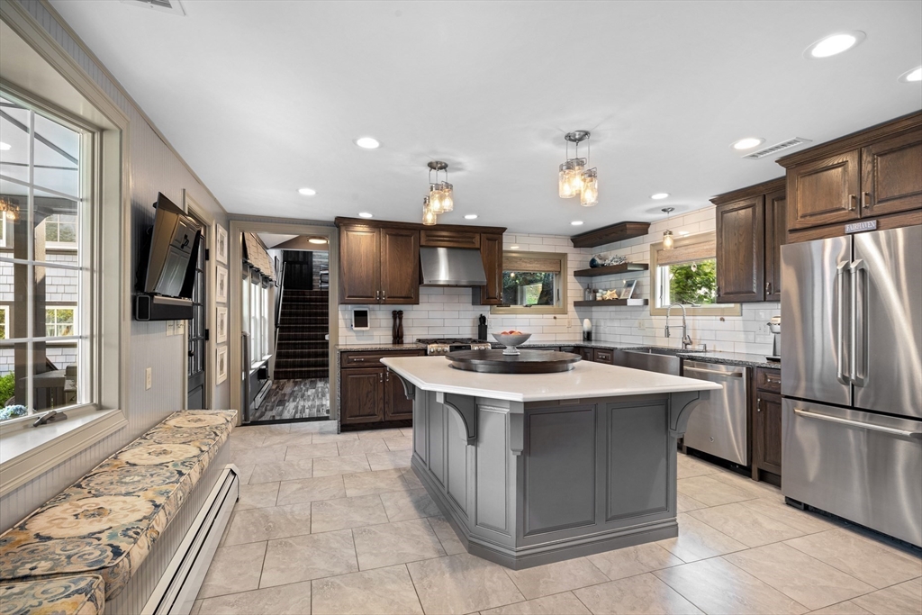 10 Cherry Street Fairhaven, MA 02719 - Photo 11 of 38 a kitchen with stainless steel appliances a sink stove refrigerator and cabinets