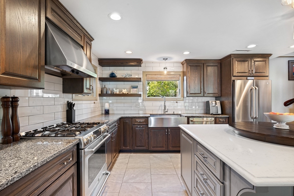 10 Cherry Street Fairhaven, MA 02719 - Photo 15 of 38 a kitchen with stainless steel appliances granite countertop a sink stove refrigerator and cabinets