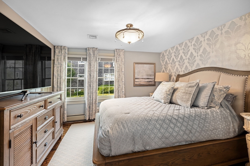 10 Cherry Street Fairhaven, MA 02719 - Photo 17 of 38 a bedroom with a bed and a flat tv screen on dresser