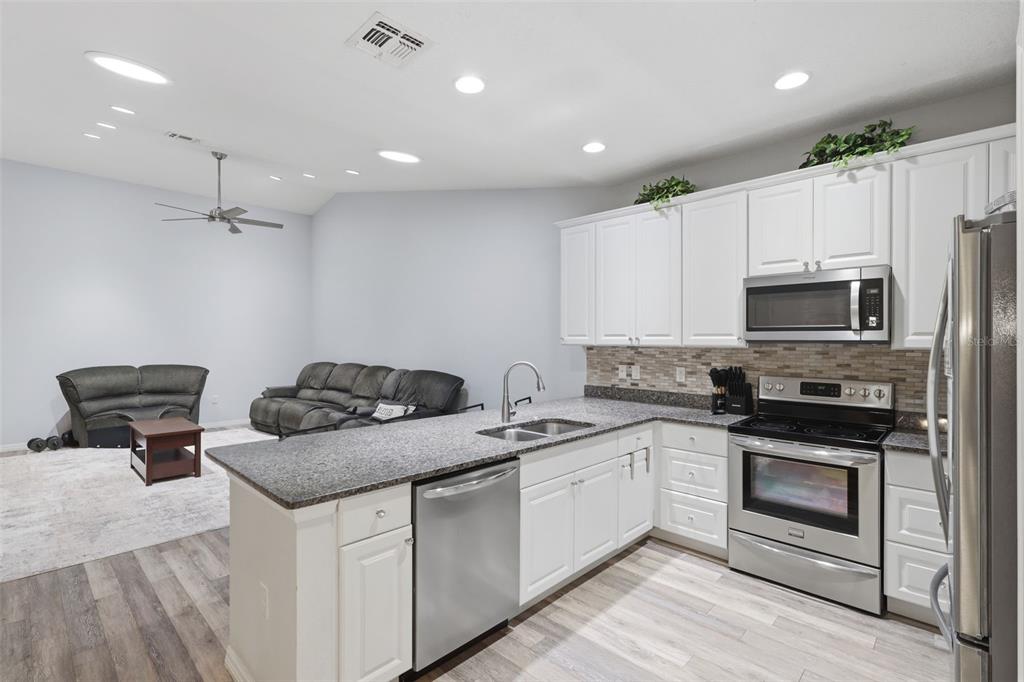 205 Merlot Street DeLand, FL 32724 - Photo 13 of 34 a kitchen that has a sink and a stove top oven