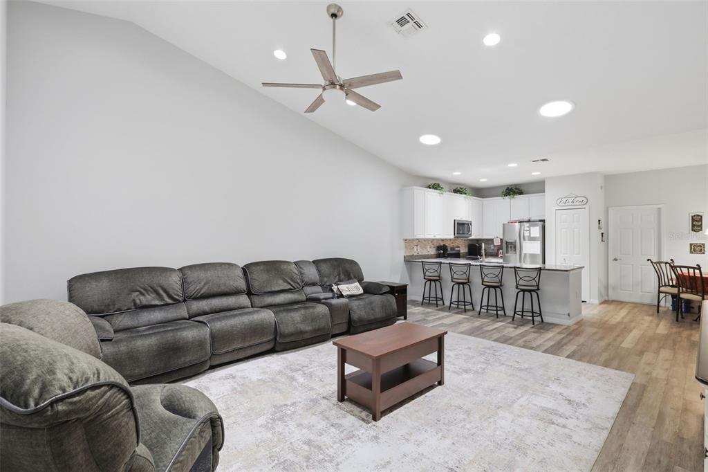 205 Merlot Street DeLand, FL 32724 - Photo 14 of 34 a living room with furniture kitchen view and a wooden floor