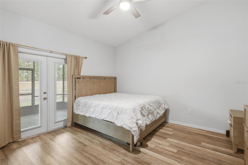 205 Merlot Street DeLand, FL 32724 - Photo 15 of 34 a bedroom with a bed and a chandelier