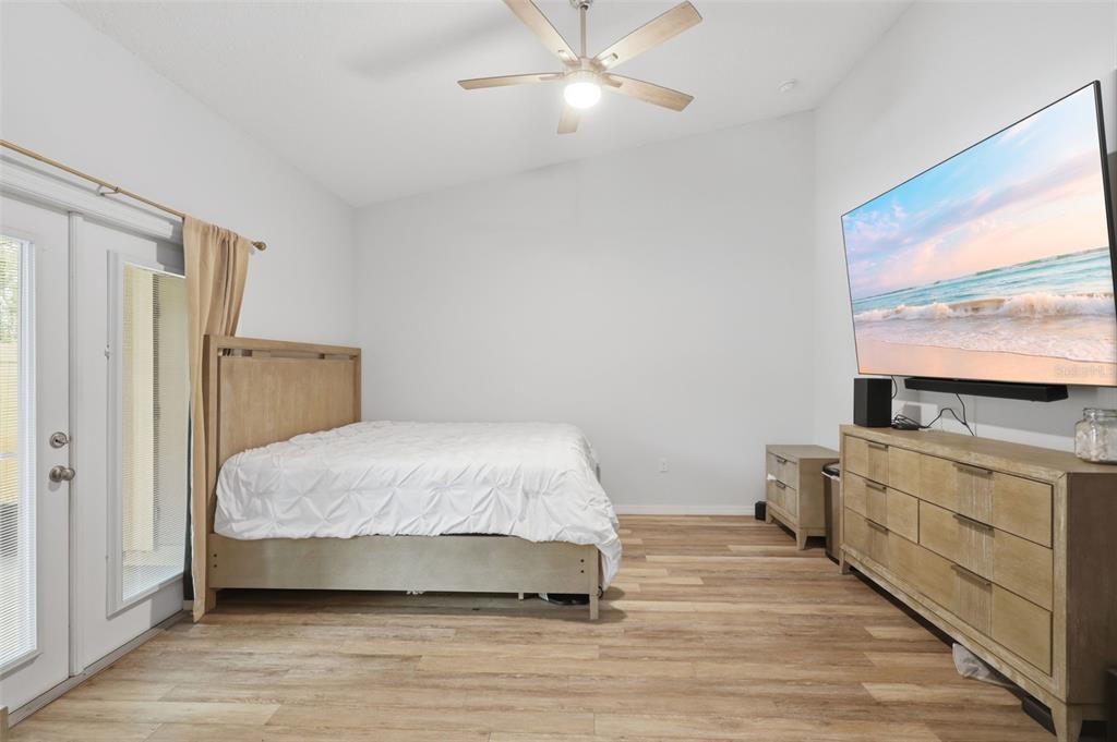 205 Merlot Street DeLand, FL 32724 - Photo 16 of 34 a bedroom with a bed and a flat screen tv