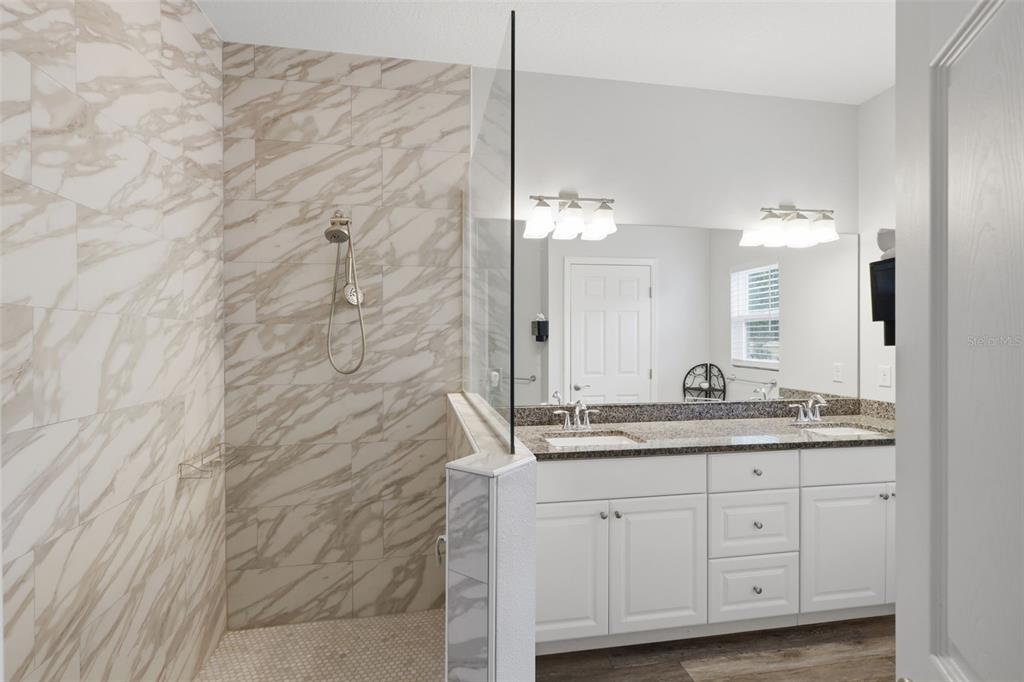 205 Merlot Street DeLand, FL 32724 - Photo 17 of 34 a bathroom with a granite countertop sink and a mirror