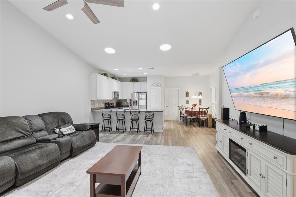 205 Merlot Street DeLand, FL 32724 - Photo 9 of 34 a living room with furniture kitchen view and a large window
