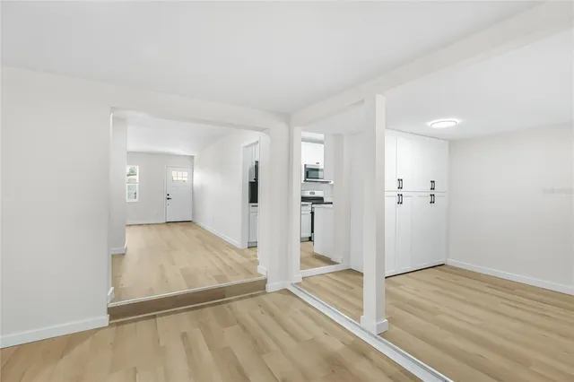 wooden floor in an empty room with a window