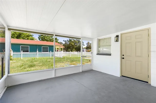 an empty room with floor to ceiling windows and pool table